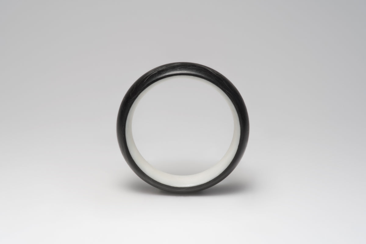 Bamboo silk and forged carbon fiber mens wedding band, front view showing the light interior